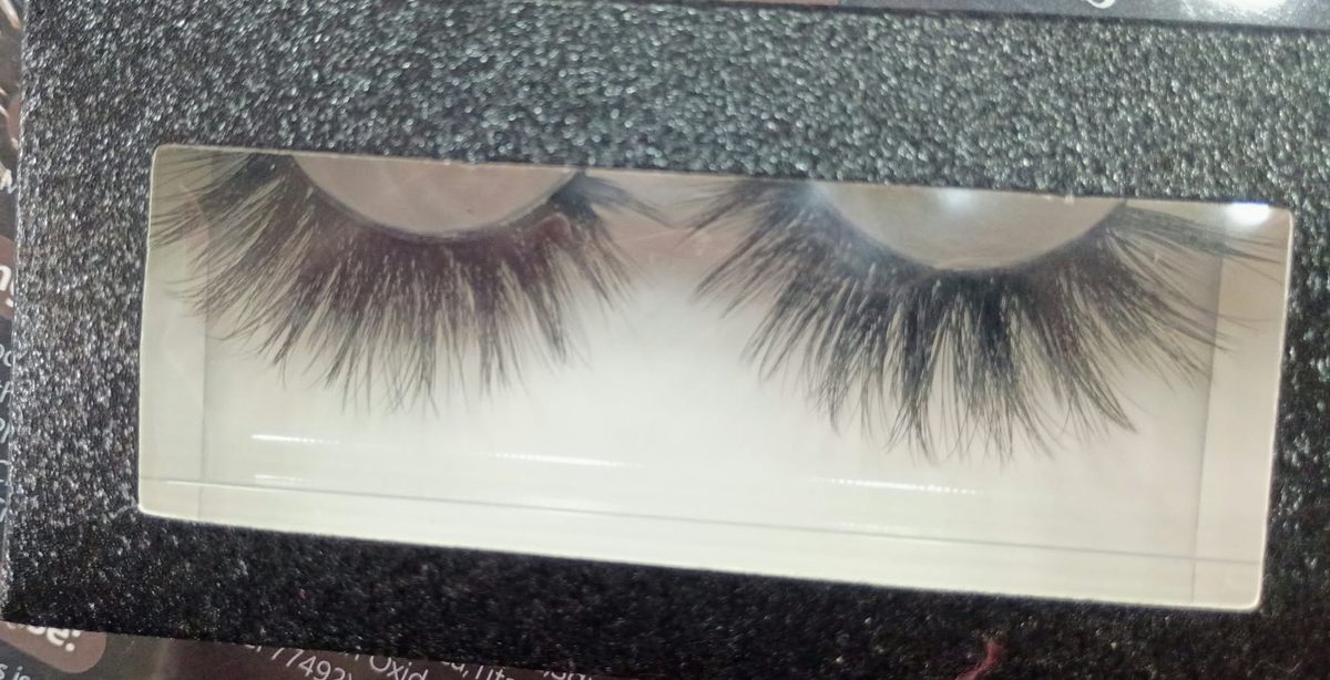 Close-up of a dramatic, long and fluffy lash pair in a black glitter window box